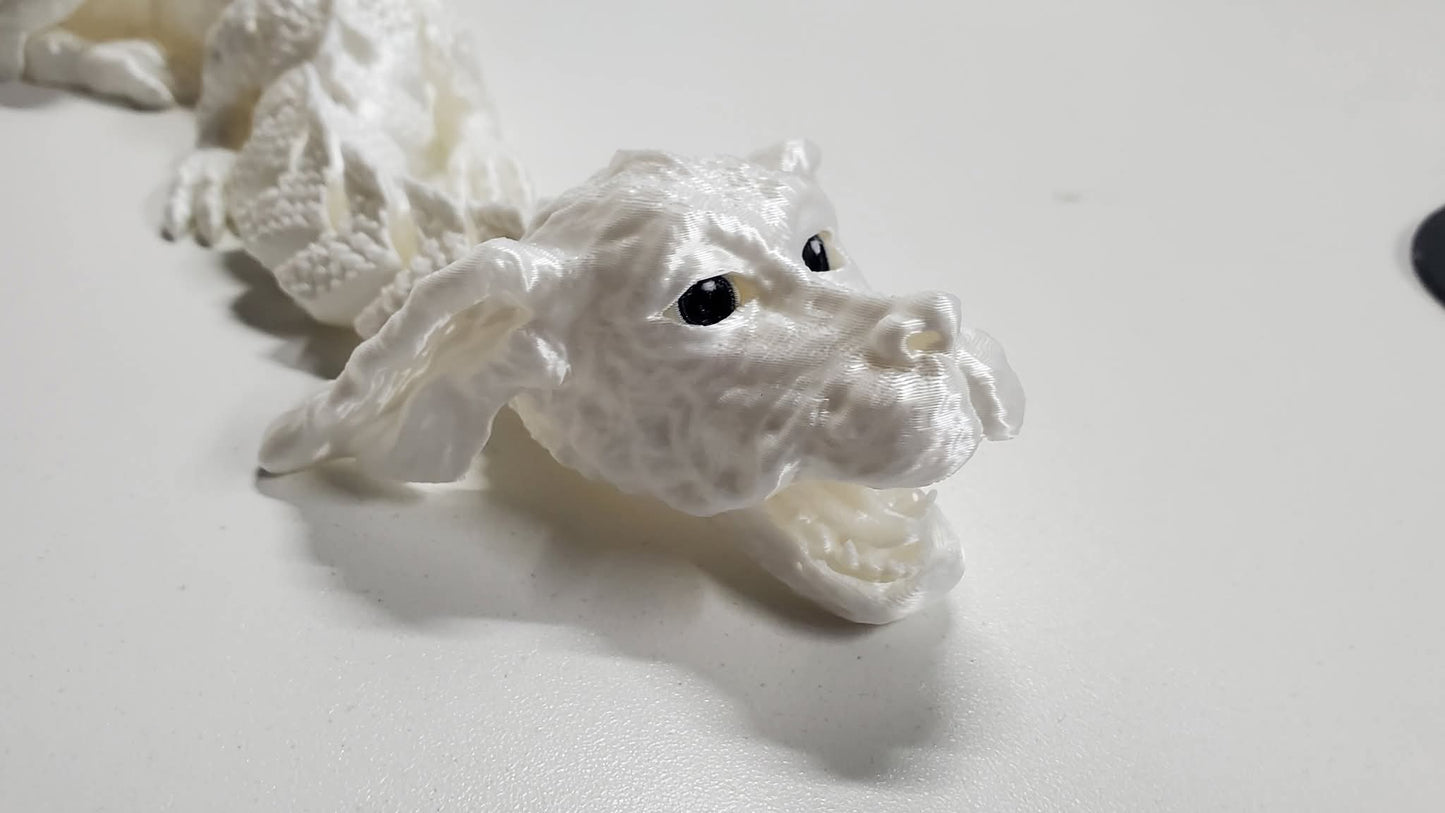 “White articulated 3D printed luck dragon figure with moving head, feet, and flexible body – detailed fantasy model.”