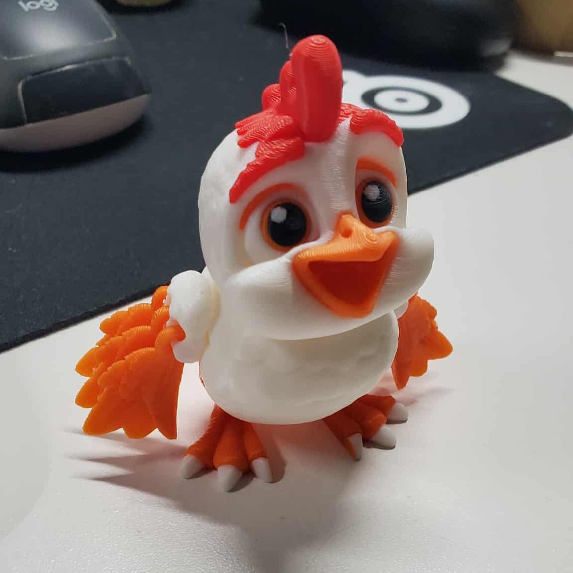 “Articulated 3D printed rooster figure with moving head, feet, and wings – cute cartoon farm animal toy.”