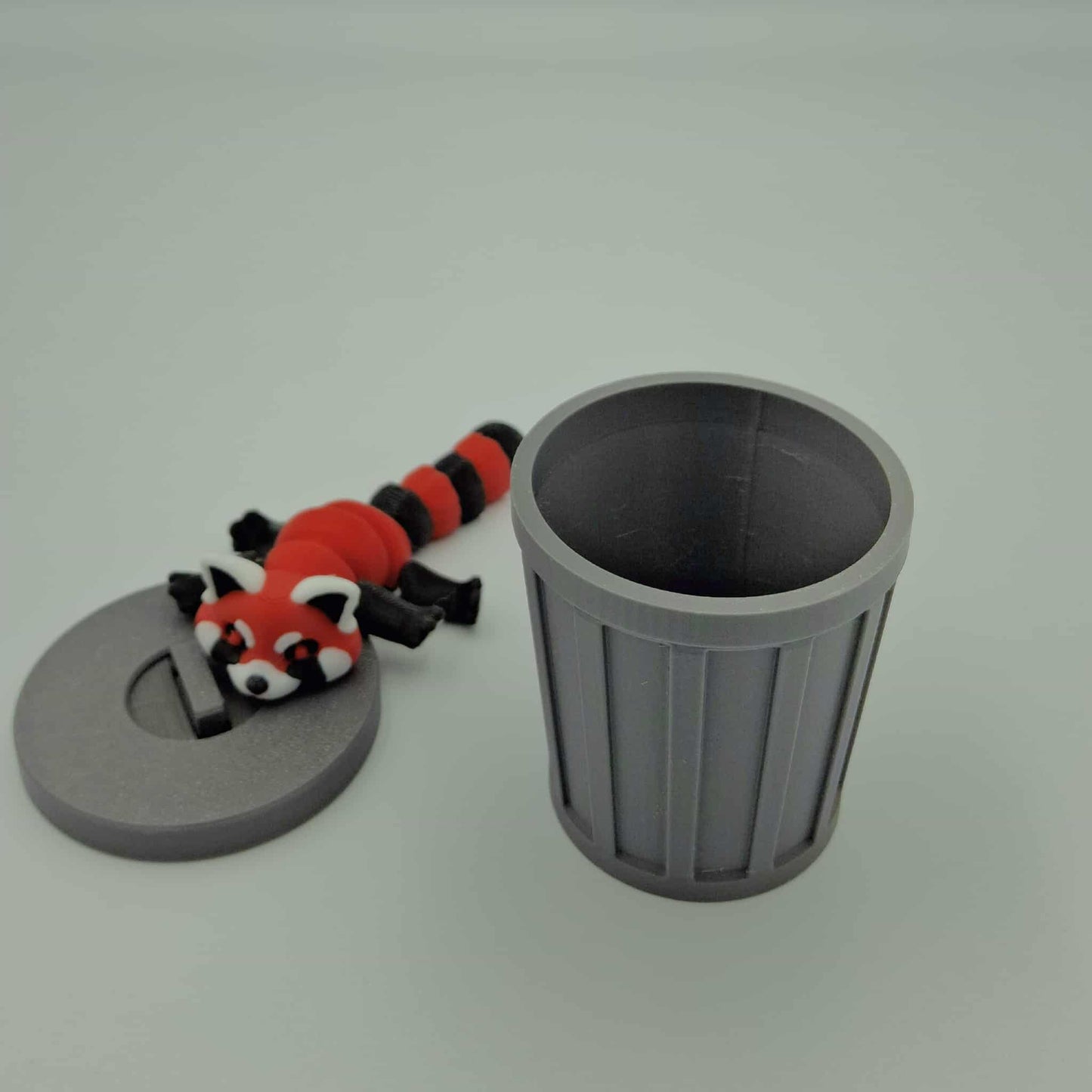 Red Panda with trash can