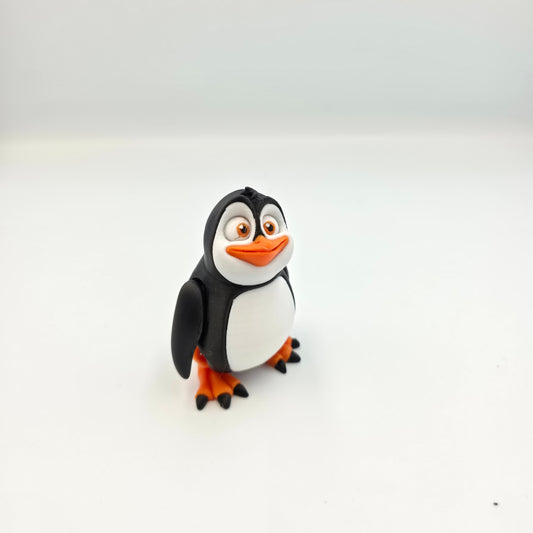 “Articulated 3D printed penguin figure with movable head, feet, and wings – cute cartoon-style toy.”