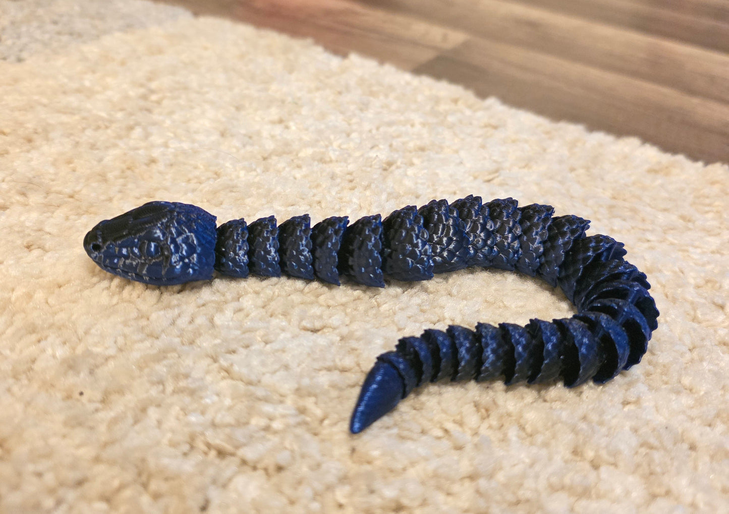 "3D printed articulated baby snake fidget toy with flexible segmented body"