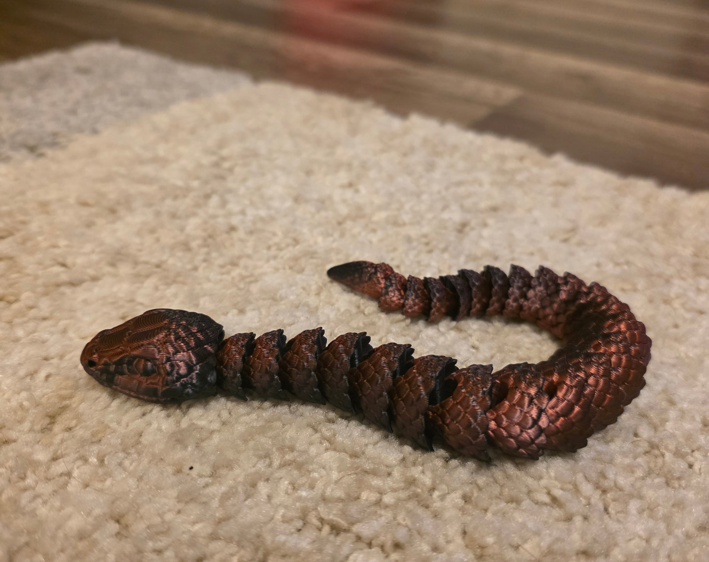 "3D printed articulated baby snake fidget toy with flexible segmented body"