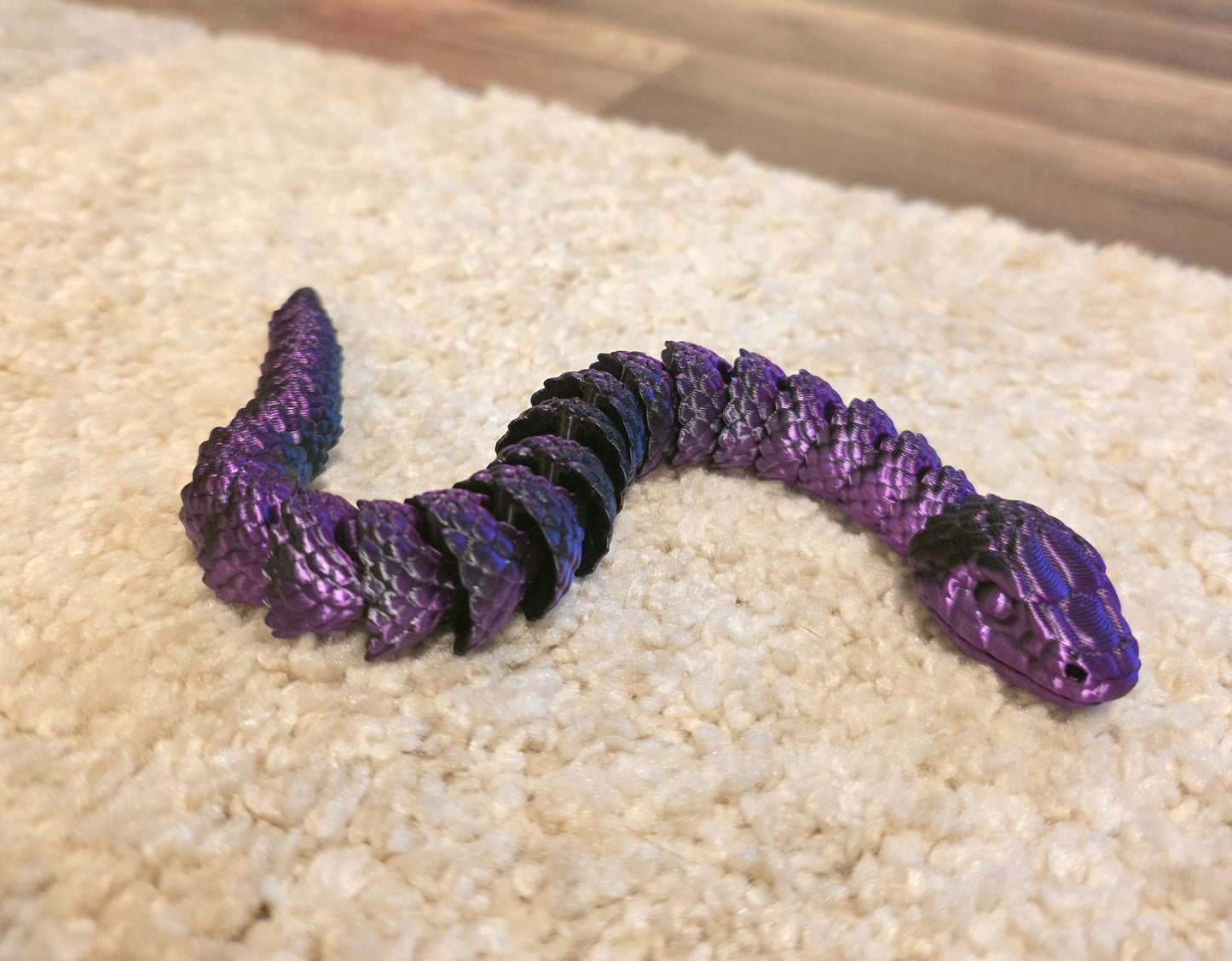 "3D printed articulated baby snake fidget toy with flexible segmented body"