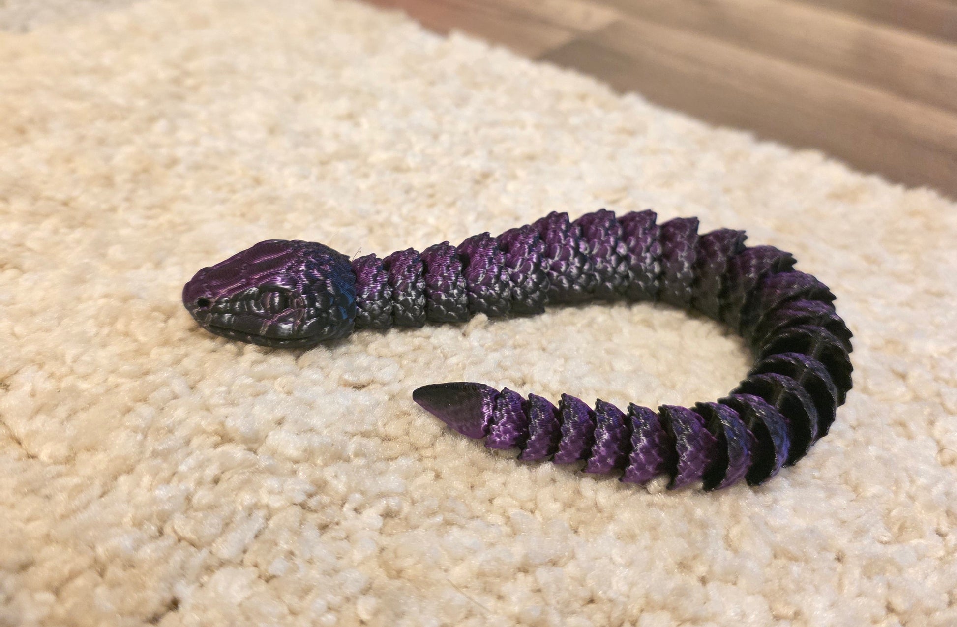"3D printed articulated baby snake fidget toy with flexible segmented body"