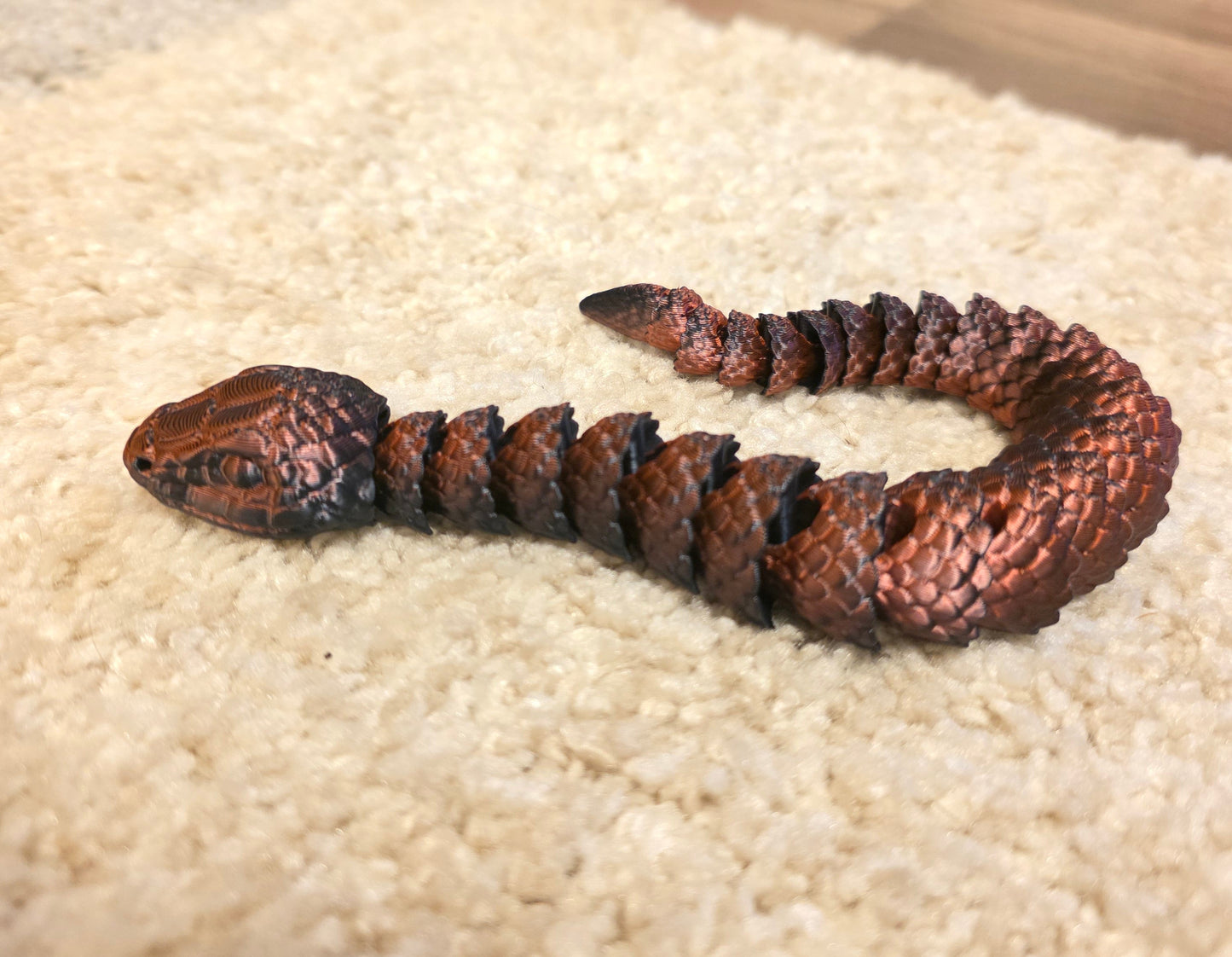 "3D printed articulated baby snake fidget toy with flexible segmented body"