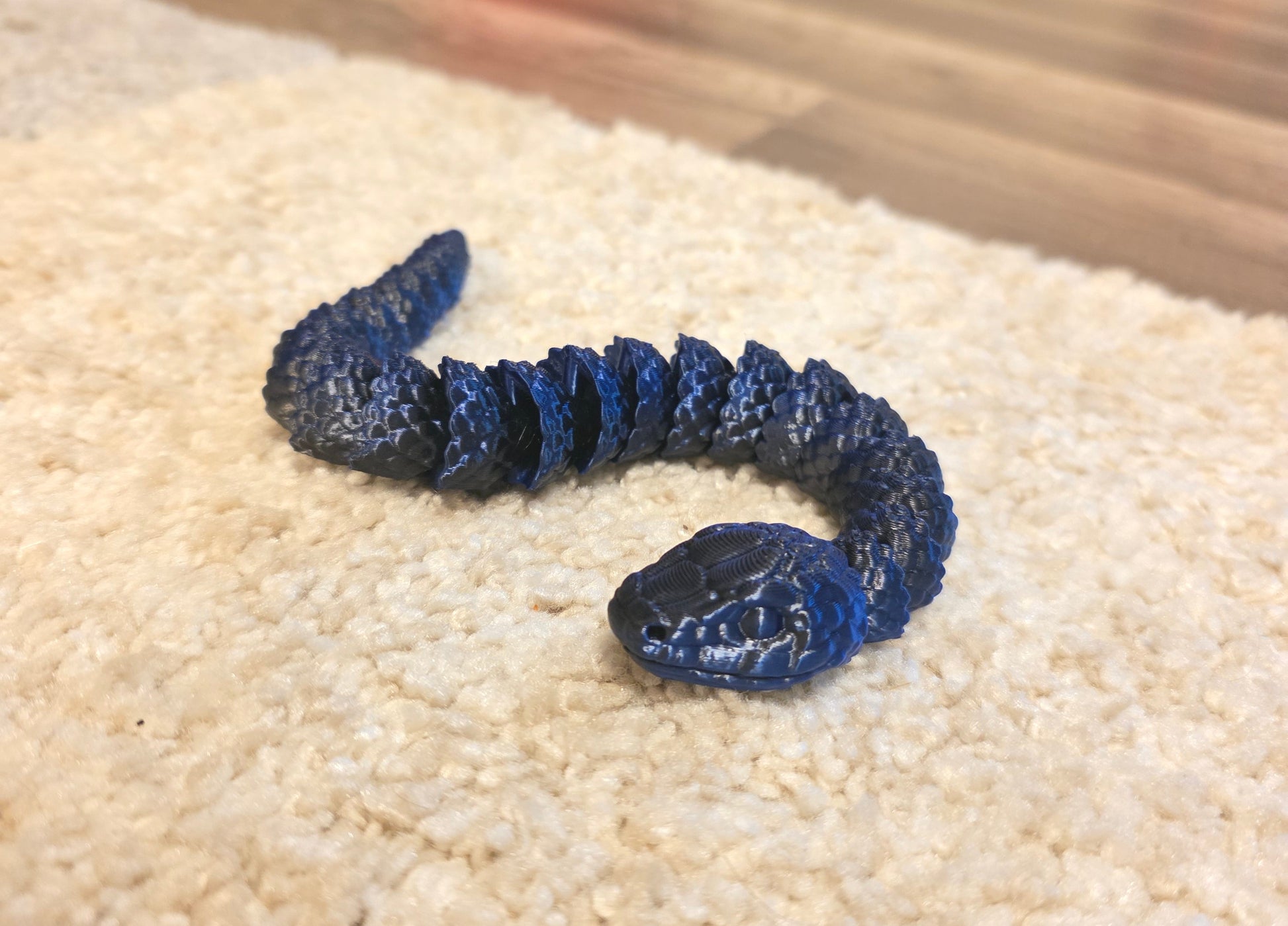 "3D printed articulated baby snake fidget toy with flexible segmented body"
